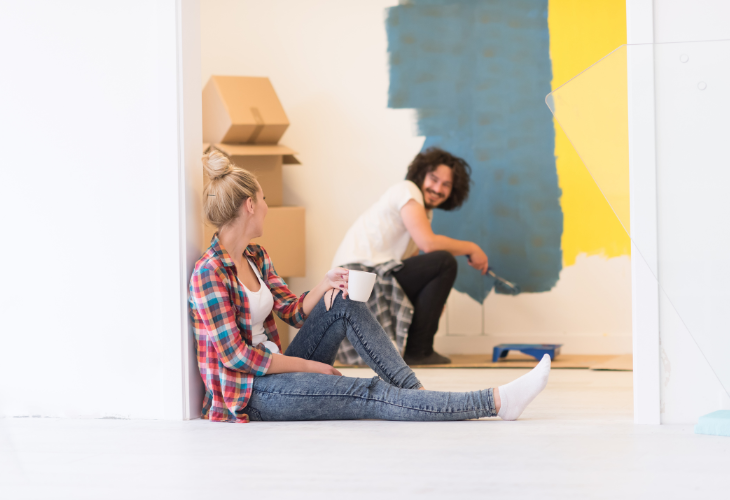 Two people sitting on the floor during a renovation